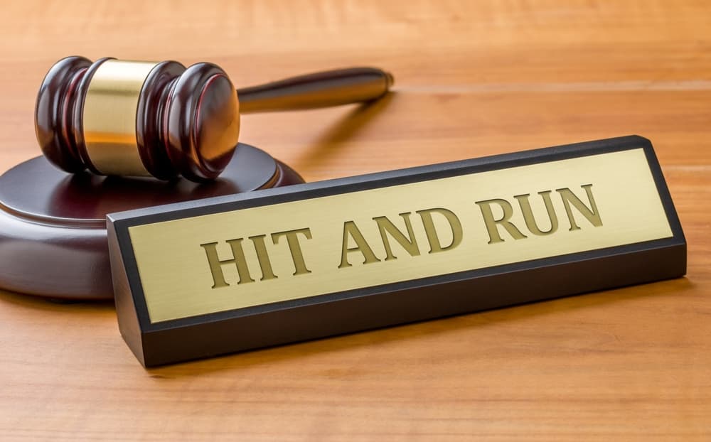 A gavel alongside a nameplate engraved with "Hit-and-Run."