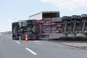 An overloaded and fast truck (TIR) has overturned on an interurban road.