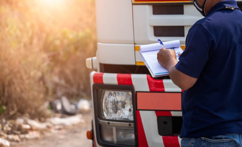 The truck driver calls the insurance company after a truck accident.