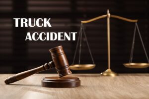 Truck Accident Law: Wooden judge's gavel and scales of justice on table.