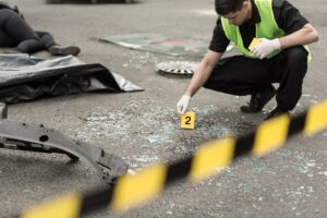 Police officer conducting an investigation at the scene of a road accident.