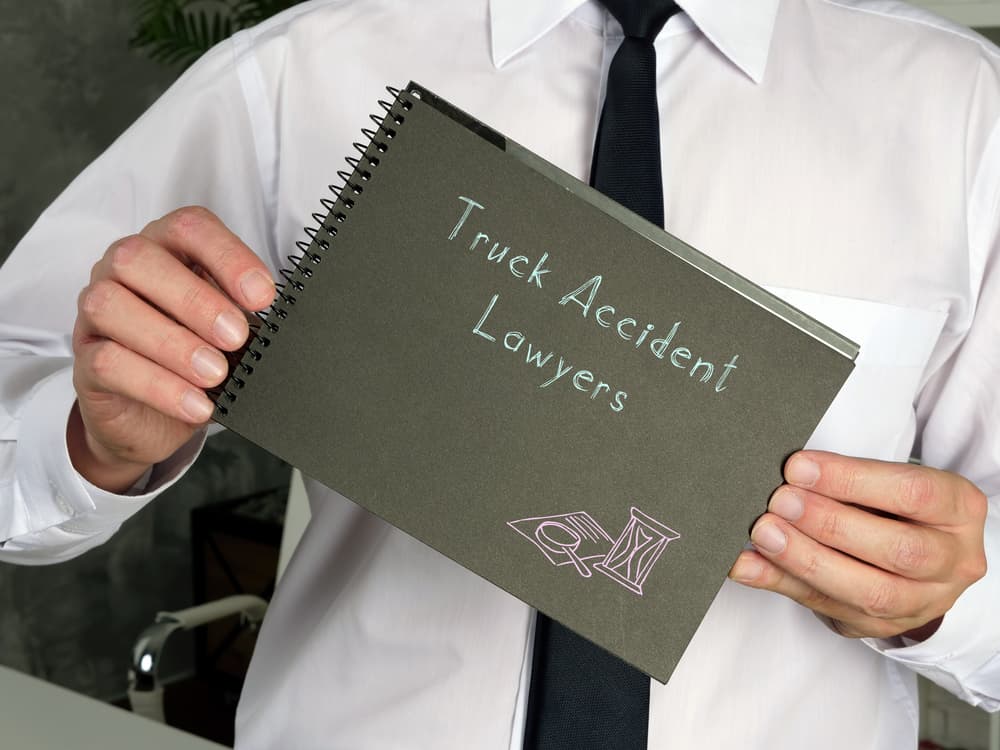 Illustration of a business concept featuring Truck Accident Lawyers, with text written on a piece of paper.