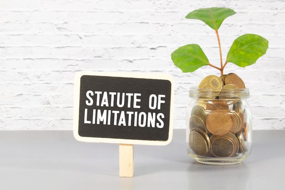 The word "Statute of Limitations" and a jar filled with coins